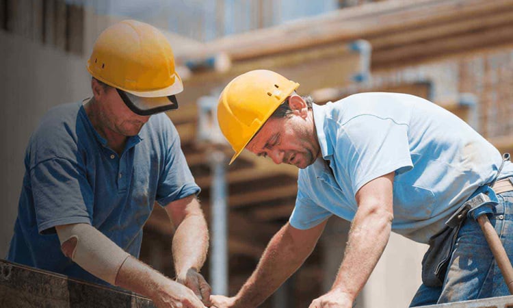 two roofing contractors working together on a project