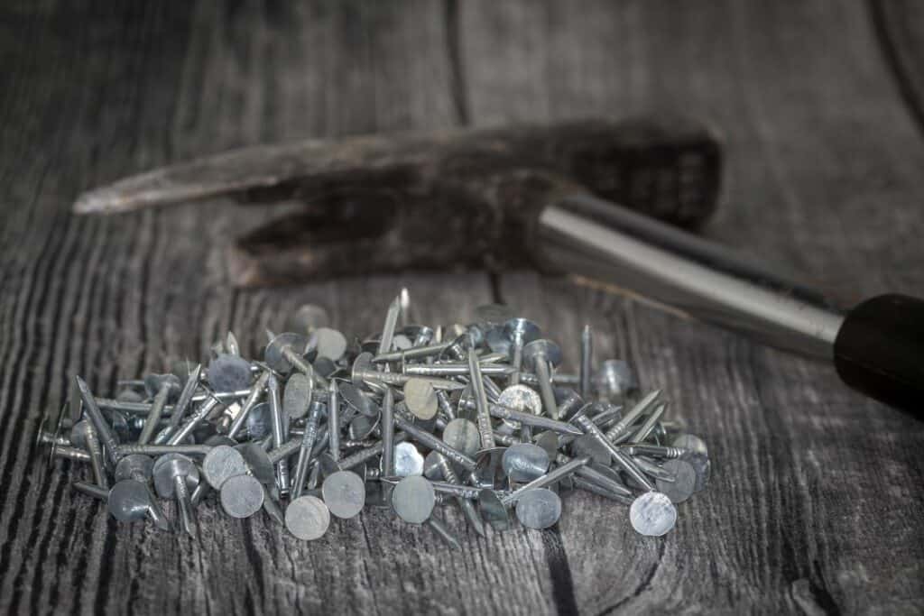 a hammer and nails used for roofing