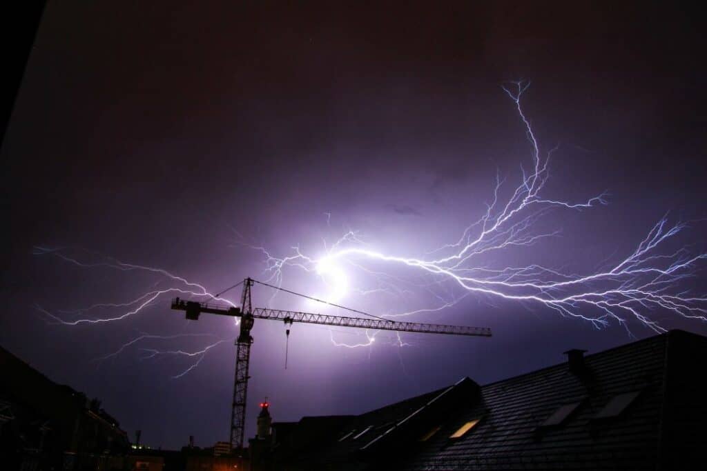 silhouette of lightning over a rooftop