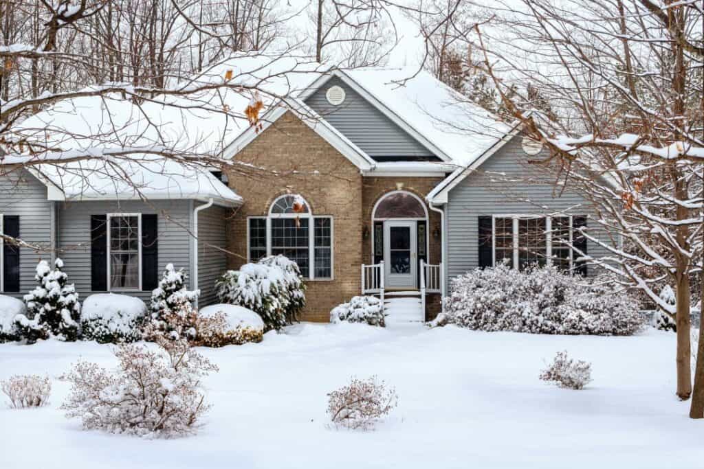 a snow-covered Dayton, Ohio home possibly in need of a roof repair