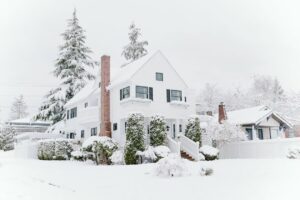 a snow coved house that may be at risk of ice dams forming