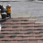 Contractor working on roof laying new shingles JW Roofing Dayton OH