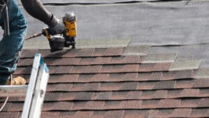 Contractor working on roof laying new shingles JW Roofing Dayton OH